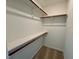Empty walk-in closet with carpet, white walls, and wood shelving at 45 Covey Rise Way, Lillington, NC 27546