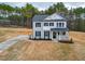 Charming two-story home with classic white and grey facade and manicured lawn at 475 Duncan Creek Rd # 142, Lillington, NC 27546