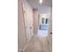 Hallway leading to a bathroom, featuring neutral paint and tiled flooring, and a storage closet at 475 Duncan Creek Rd # 142, Lillington, NC 27546