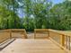 Wooden back deck with wooden railings overlooking a wooded backyard provides privacy at 63 Whimbrel Ct, Lillington, NC 27546