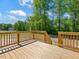 Wooden back deck with wooden railings overlooking a wooded backyard at 63 Whimbrel Ct, Lillington, NC 27546