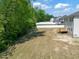 View of the spacious backyard with a small deck attached to the home at 63 Whimbrel Ct, Lillington, NC 27546