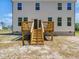 Backyard featuring a wooden deck and steps that lead down to the yard at 63 Whimbrel Ct, Lillington, NC 27546