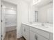 Bathroom features a double vanity, framed mirror, and wood look flooring at 63 Whimbrel Ct, Lillington, NC 27546