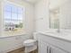 Bright bathroom featuring a large window, toilet, and vanity at 63 Whimbrel Ct, Lillington, NC 27546