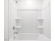 Clean bathroom features a shower and tub combination with built in shelves at 63 Whimbrel Ct, Lillington, NC 27546