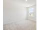 Carpeted bedroom featuring a large window with natural light at 63 Whimbrel Ct, Lillington, NC 27546