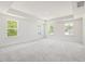 Spacious bedroom with a tray ceiling and three large windows allowing ample natural light at 63 Whimbrel Ct, Lillington, NC 27546