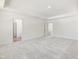 Bright bedroom with plush carpeting, tray ceilings, and neutral-toned walls at 63 Whimbrel Ct, Lillington, NC 27546