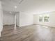 Large bonus room features hardwood flooring, two windows and two doors at 63 Whimbrel Ct, Lillington, NC 27546