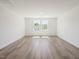 Bright bonus room with two windows and wood laminate flooring at 63 Whimbrel Ct, Lillington, NC 27546