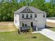 Charming two-story home boasts a well-maintained lawn and inviting front porch at 63 Whimbrel Ct, Lillington, NC 27546