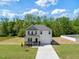 Charming two-story home boasts a well-maintained lawn and inviting front porch at 63 Whimbrel Ct, Lillington, NC 27546