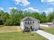 Charming two-story home boasts a well-maintained lawn and inviting front porch at 63 Whimbrel Ct, Lillington, NC 27546