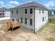 A view of the house, showing the vinyl siding, windows, and wooden back porch at 63 Whimbrel Ct, Lillington, NC 27546