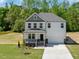 Charming two-story home boasts a well-maintained lawn and inviting front porch at 63 Whimbrel Ct, Lillington, NC 27546