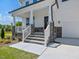 Inviting front porch with stone accents and a well-manicured lawn at 63 Whimbrel Ct, Lillington, NC 27546
