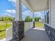 Inviting front porch with stone accents and white railing at 63 Whimbrel Ct, Lillington, NC 27546