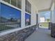 Inviting front porch with stone accents and white railing at 63 Whimbrel Ct, Lillington, NC 27546