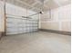 Spacious garage with concrete floors, brick foundation and an automatic garage door at 63 Whimbrel Ct, Lillington, NC 27546