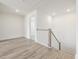 Bright hallway features hardwood floors, and a staircase with wood and white railings at 63 Whimbrel Ct, Lillington, NC 27546