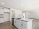 An open kitchen features white cabinetry, granite countertops, and stainless steel appliances at 63 Whimbrel Ct, Lillington, NC 27546