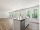 An open concept living space features a kitchen island with granite countertops at 63 Whimbrel Ct, Lillington, NC 27546