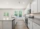 New kitchen features granite countertops, stainless appliances, and hardwood floors at 63 Whimbrel Ct, Lillington, NC 27546
