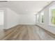 Bright living space with white walls, ample natural light, and modern wood-look floors at 63 Whimbrel Ct, Lillington, NC 27546