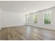 Bright, spacious living room with new flooring and multiple windows offering scenic views at 63 Whimbrel Ct, Lillington, NC 27546