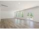Spacious living room with wood-look floors, white walls, and door to patio at 63 Whimbrel Ct, Lillington, NC 27546