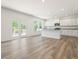 Open-concept living space features white cabinets, granite counters and access to outdoor deck at 63 Whimbrel Ct, Lillington, NC 27546