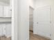 Hallway nook adjacent to the kitchen leads to a pantry with wire shelving at 63 Whimbrel Ct, Lillington, NC 27546