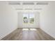 Room with coffered ceiling, two windows, light wood-look flooring, and white walls at 63 Whimbrel Ct, Lillington, NC 27546