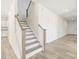 Staircase with wood handrail leads to the second level of the home at 63 Whimbrel Ct, Lillington, NC 27546