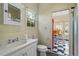 Bright bathroom includes a vanity, toilet, and access to a sunroom with checkerboard floor at 106 Alder Pl, Chapel Hill, NC 27517