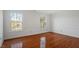 Bright bedroom with hardwood floors and two windows at 106 Alder Pl, Chapel Hill, NC 27517