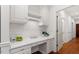 White kitchen with built-in desk and access to hallway at 106 Alder Pl, Chapel Hill, NC 27517