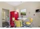 Retro kitchenette with red refrigerator, yellow stools, and vintage cabinetry at 106 Alder Pl, Chapel Hill, NC 27517