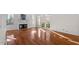 Sunlit living room features hardwood floors, fireplace, and access to backyard at 106 Alder Pl, Chapel Hill, NC 27517