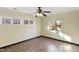 Bright bedroom with wood-look floors, ceiling fan, and multiple windows at 414 Clayton Rd, Durham, NC 27703