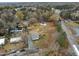 Aerial view of a compact home on a large lot with a big backyard and a shed, near the road at 670 Mcadams Rd, Hillsborough, NC 27278