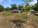 Aerial view of a gray house on a large lot with an outbuilding and a firepit at 670 Mcadams Rd, Hillsborough, NC 27278