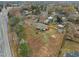 Aerial view of a compact home on a large lot with a big fenced-in backyard and a shed at 670 Mcadams Rd, Hillsborough, NC 27278
