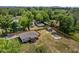 Overhead shot shows house on large lot surrounded by mature trees and an outbuilding at 670 Mcadams Rd, Hillsborough, NC 27278