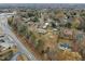 Aerial view of a compact home on a large lot with a big, fenced-in backyard and a shed at 670 Mcadams Rd, Hillsborough, NC 27278