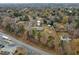 Aerial view of a small home on a large lot with a large, fenced in backyard. Located in wooded neighborhood at 670 Mcadams Rd, Hillsborough, NC 27278