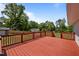 Spacious wooden deck with red railing offers space for relaxing and entertaining at 670 Mcadams Rd, Hillsborough, NC 27278