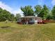 Spacious yard with a home featuring a vibrant deck, perfect for outdoor relaxation and entertaining guests at 670 Mcadams Rd, Hillsborough, NC 27278