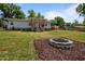 Picture of home and front yard featuring fire pit, light gray siding, and red porch at 670 Mcadams Rd, Hillsborough, NC 27278